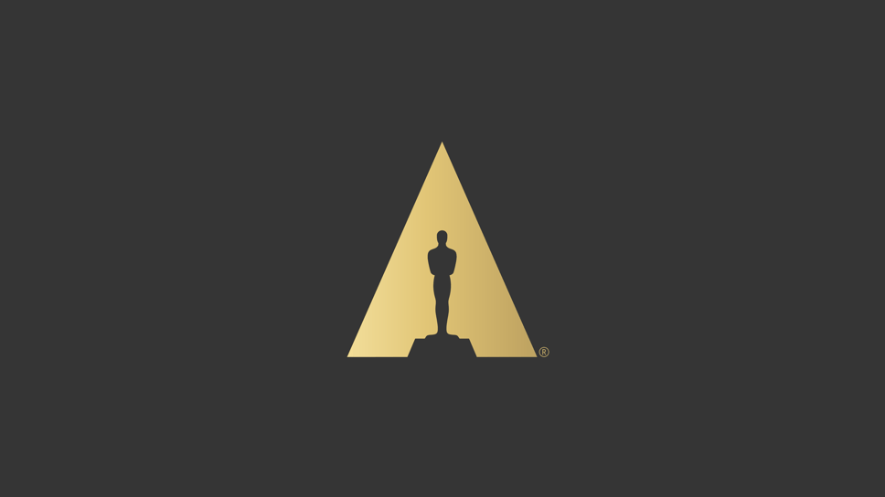 The Academy's Scientific and Technical Awards logo, a gold triangle framing the Oscar statuette silhouette against a charcoal field