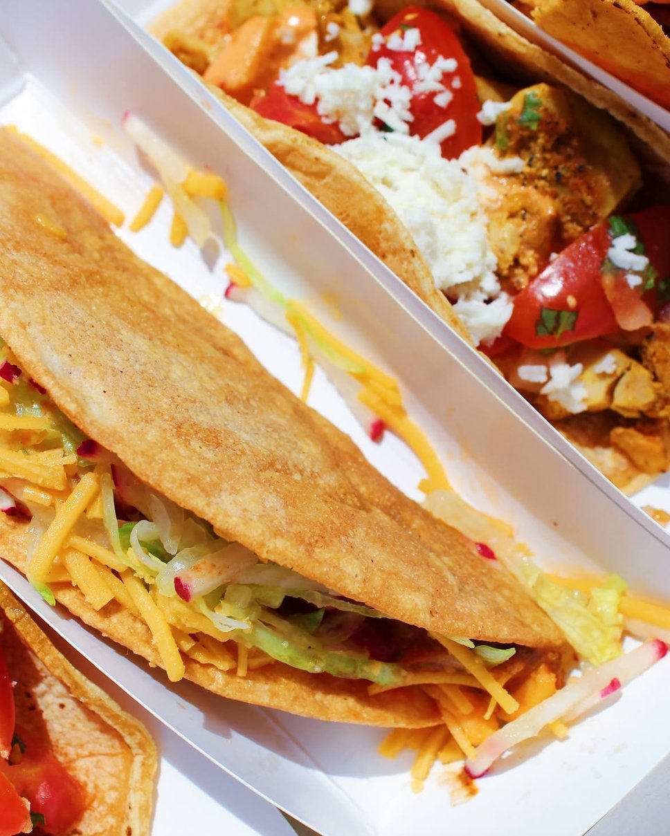 A crispy taco with cheddar, shredded lettuce and radish · 📸 PHOTO VIA @CHICASTACOS