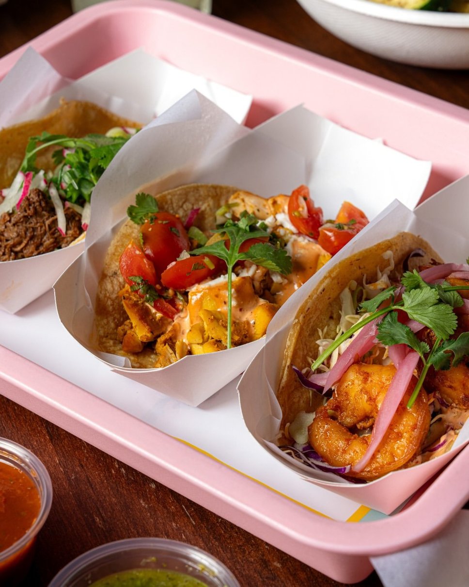 Braised pork, chicken and shrimp tacos on the house pink tray · 📸 PHOTO VIA @CHICASTACOS