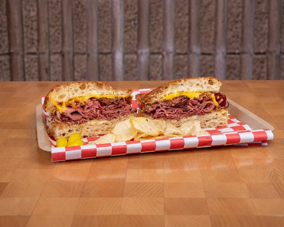 The Chrissy: RC Provisions pastrami, caramelized onions, American cheese and brown mustard · 📸 PHOTO VIA FRANK N' FRANKS
