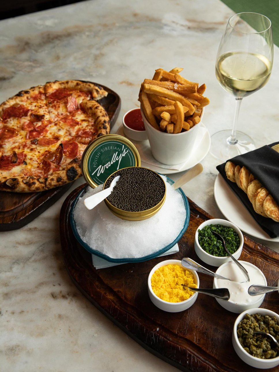 Caviar service alongside pinsa and frites Β· @wallysofficial