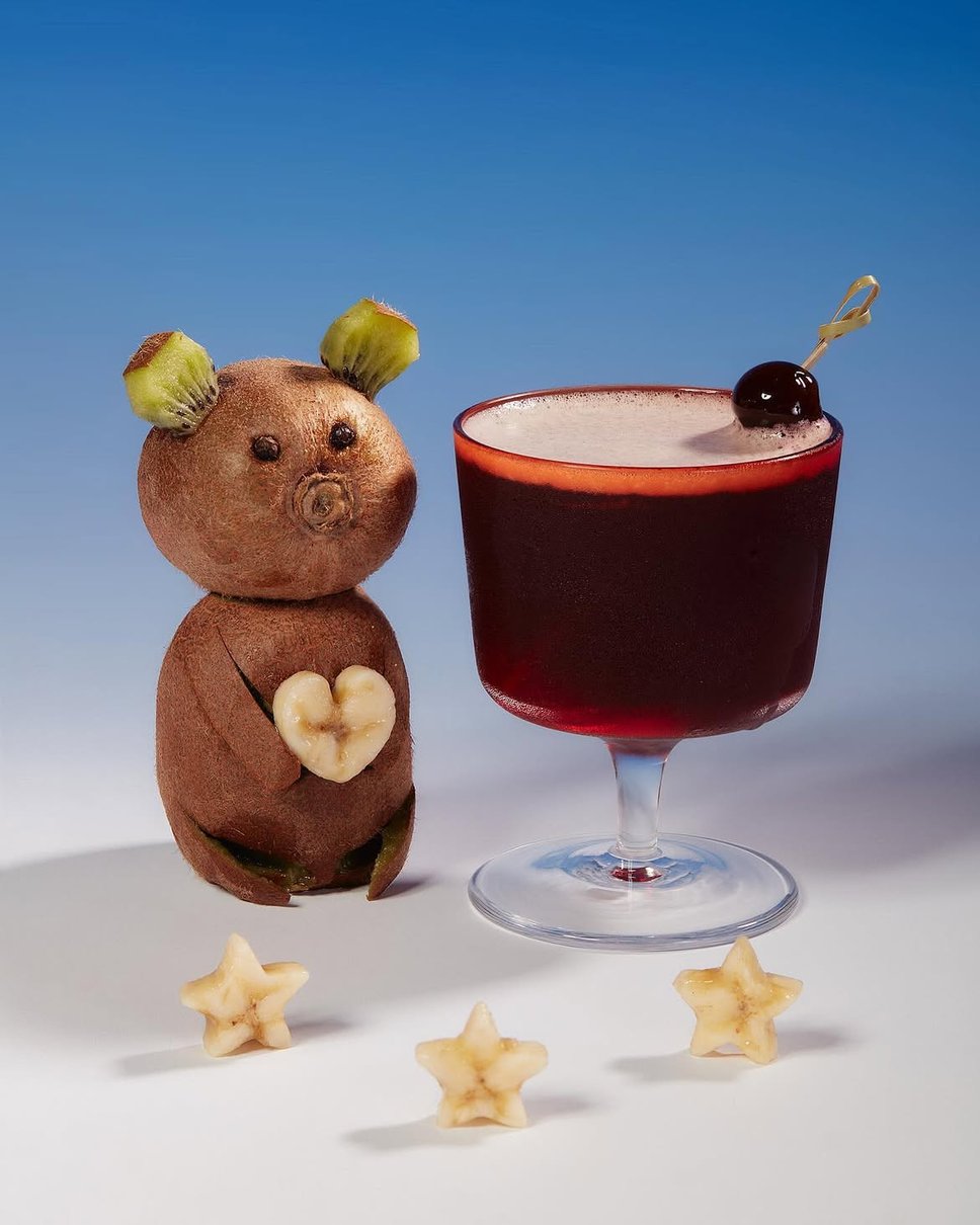 A signature cocktail served at Mood Ring. To the left is a stuffed teady bear.