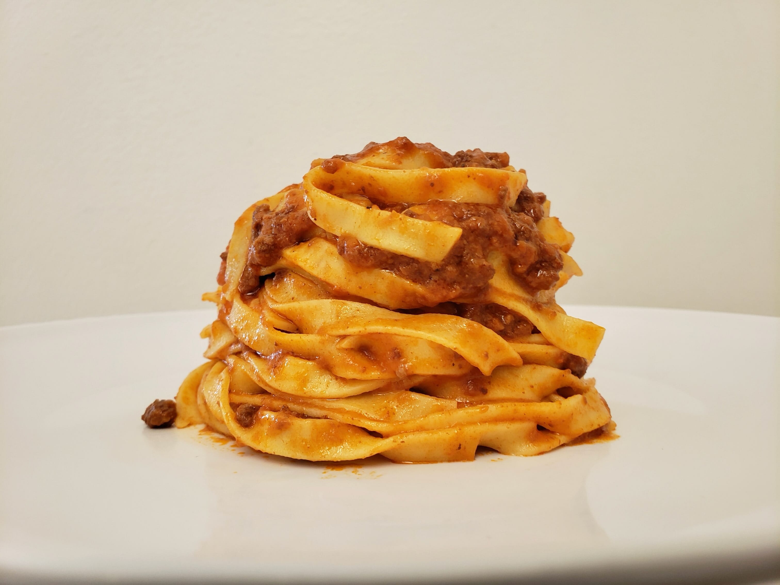 Pasta Sisters ribbon pasta with sauce on a white plate.