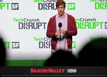 A Silicon Valley character greets the audience on the TechCrunch Disrupt stage.