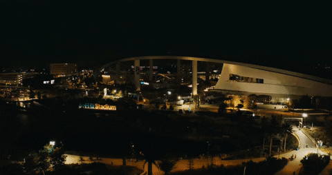 SoFi Stadium illuminated at night.