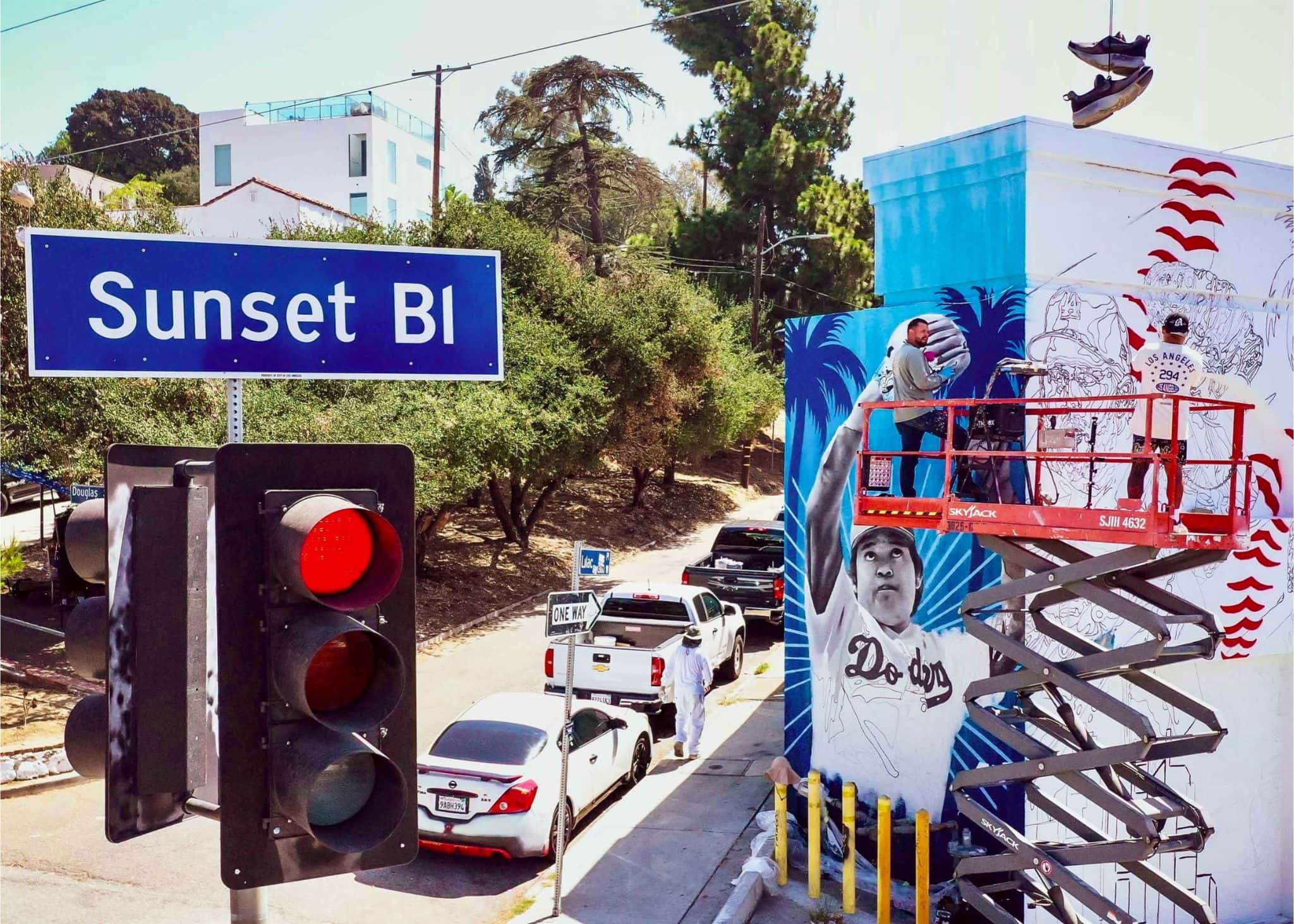 Artists paint the exterior mural at The Ravine Club on Sunset Boulevard in Echo Park.